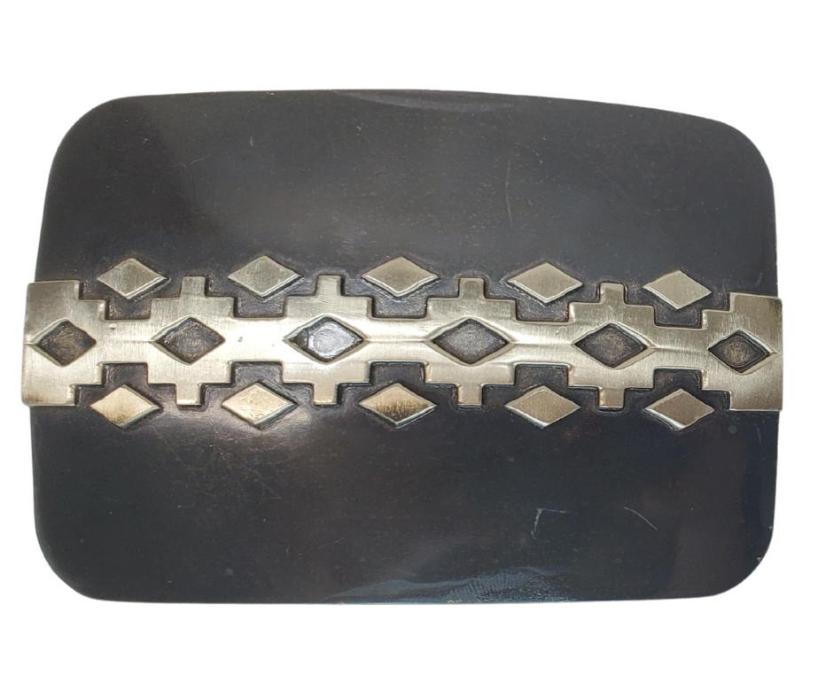 The 'Aztec Trail' Belt Buckle features a unique pattern on a Patina background, giving it a retro yet minimalist look. It can accommodate belts up to 1 3/4" wide without digging into your stomach, and measures 2 3/8" H x 3 1/2" W. Crafted with Zinc in Mexico, you can purchase it at our convenient Smyrna, TN location near bustling downtown Nashville.