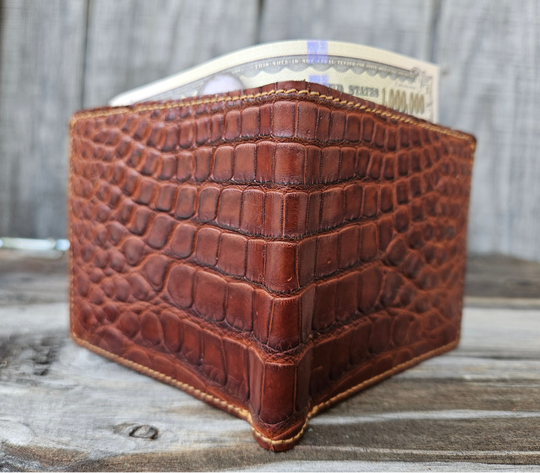 If you appreciate Hi-end craftmanship this USA Made Genuine Alligator in slight Matte Brown. Matching Alligator inside Lining with 1 Bill Pocket, 8 Card Slots, 2 Inner Side Pockets. Each hide and wallet is unique! Handmade in USA and sold in our Smyrna, TN shop not far from the gulch downtown Nashville.

Thin profile