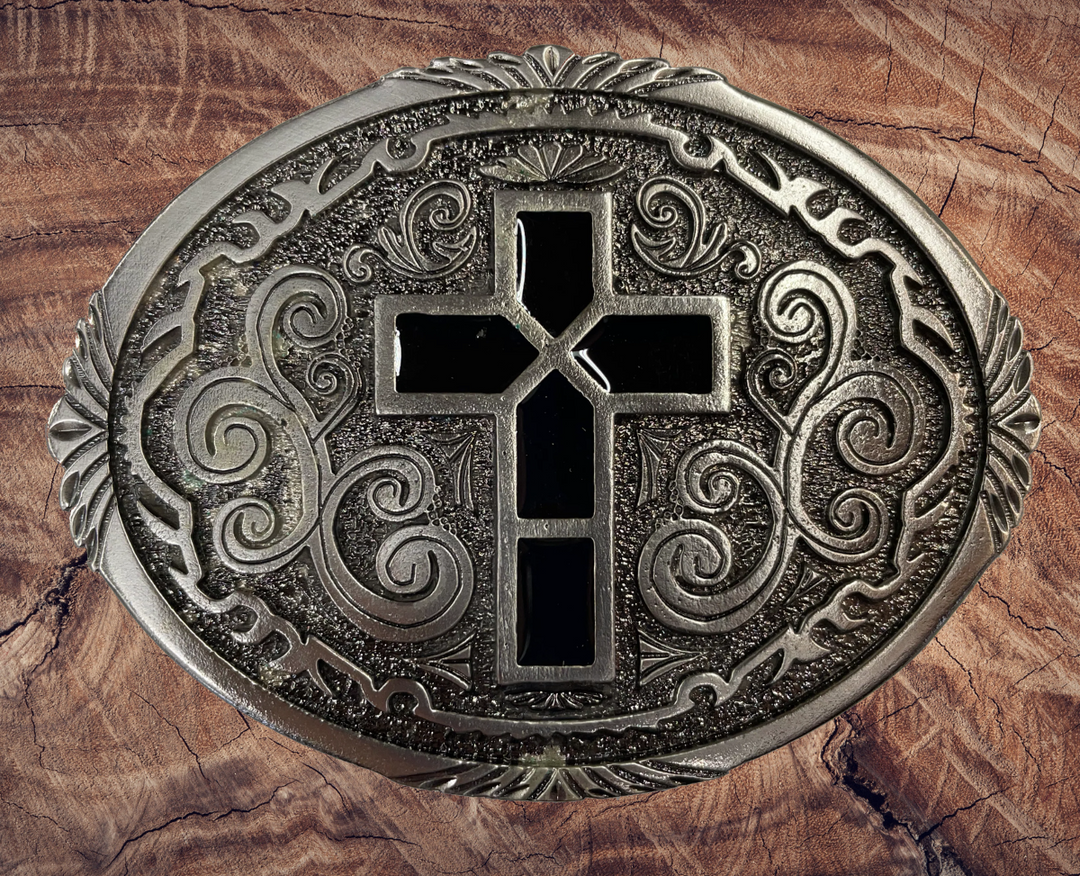 Pewter belt buckle that may be attached to your belt.  It has a western style oval shape with Black epoxy inlay cross in the center. Fits 1 1/2" belts, Size 3-1/2" x 2-3/4. Available in our shop just outside Nashville in Smyrna, TN.