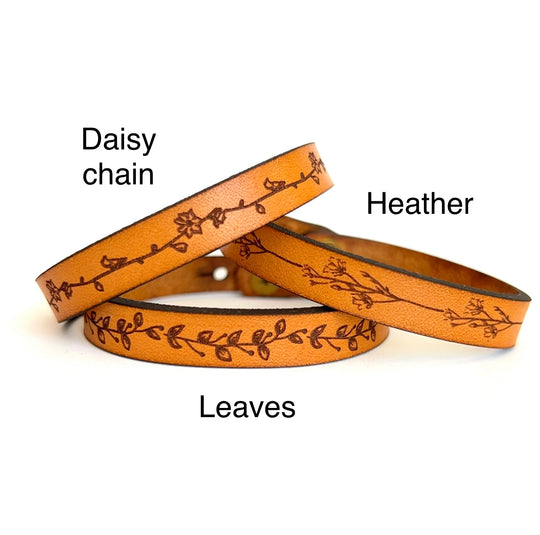 Assorted Floral Laser Engraved Bracelets made from full grain leather. This classic style leather bracelet works great for stacking with each other or any other bracelets. Floral designs are a Daisy Chain, Heather, and Leaves. Closure is a button stud, and adjustable: 7 and 7 1/2 x 3/8 in. Stocked at our Smyrna, TN shop.