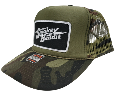 Take risks and show your adventurous spirit with our black and green camo mesh vintage foam trucker Smoky and the Bandit cap! The iconic Bandit logo meets the USA flag in this unique design. Get yours now at our Smyrna, TN store or online for the ultimate challenge and inspiration! Snap back adjustment.