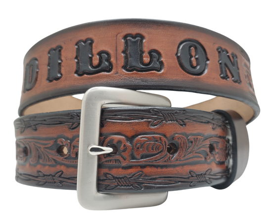 The "Bandit" Name Belt is perfect for those seeking an epic escape. It's handcrafted in Smyrna, Tennessee, just outside Nashville, and features a 1 1/2" width with a strip of vegetable tanned leather. The bold design includes an embossed Barbwire border and Western Scroll center pattern, while the changeable solid brass buckle in antique nickel finish adds a rugged touch. Make your escape in style with this hand-stained belt.