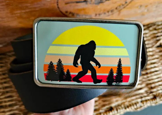 The Sunset Bigfoot is one of most unique belt buckles that are completely metal (image area too) and are made to be durable and lasting! Lots of details in the image and slightly smaller than most of our buckle selection. Available at our Smyrna, TN shop a short ride from downtown Nashville.

Belt Buckle Measures: -3"x2"
Fits any snap belt up to 1 1/2"
Listing is for the belt buckle only & does not include a belt strap.