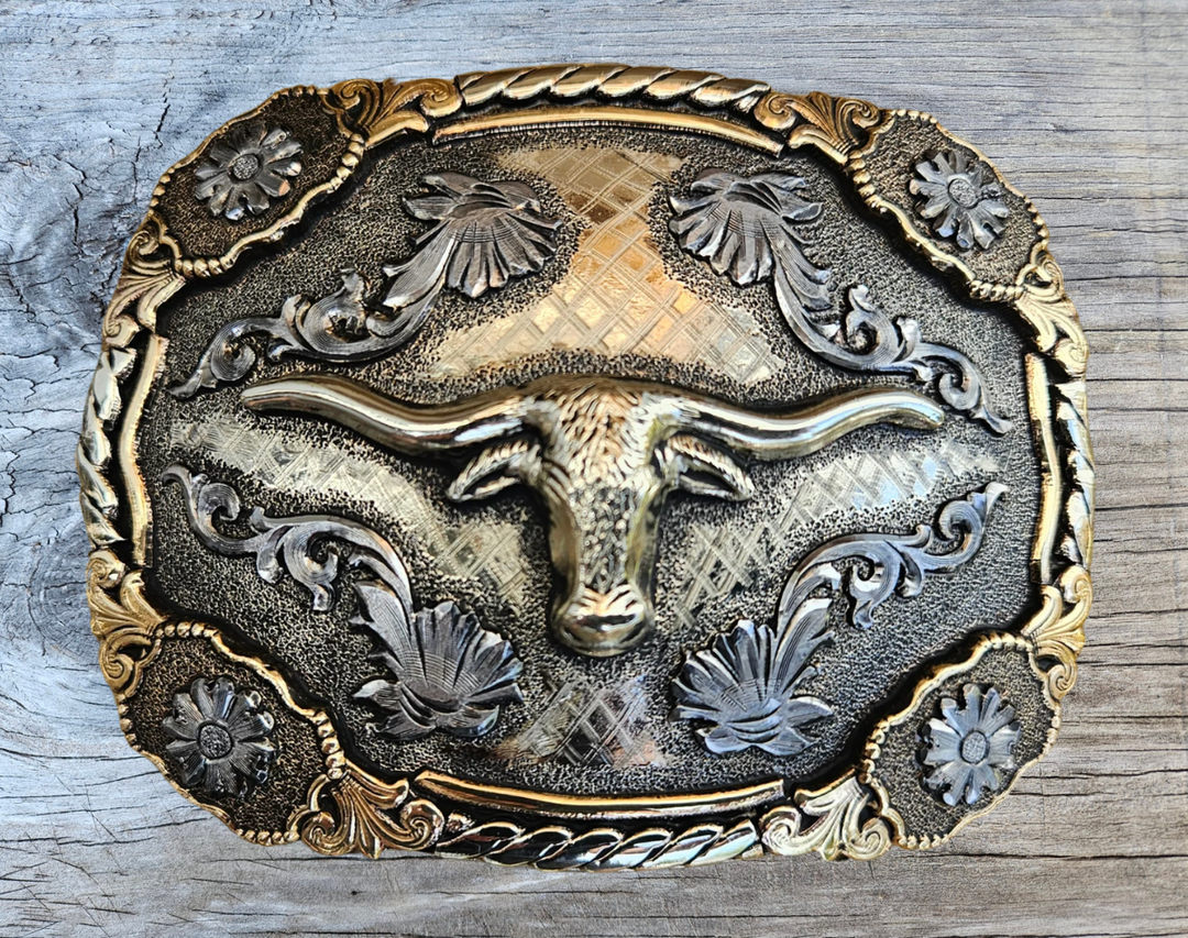The Bessie Moo Belt Buckle has the ever classic Longhorn design accented with a multi Western scrolls, a hint of Rope on the edge with 4 Flower rosettes. A Classic Western belt buckle at it&