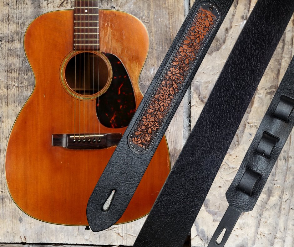 Acoustic Guitars and Great Songs and Lyrics have been staple for years in Country music!  "This 2" or 2 1/2" wide Guitar Strap is a nod to that classic influence. The main Body of the strap is approx. 1/8" thick Black Leather Strap with a CUSTOMIZABLE Flowered LEATHER PATCH. The classic adjustment style goes from approx. 42" to 56" at it's longest . Made just outside Nashville in our Smyrna, TN. shop. It will need a bit of time to "break in" but will get a great patina over time. 