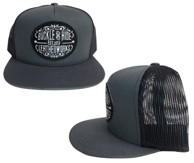 Upgrade your cap game with the Buckle and Hide Classic Flat Bill Trucker Cap, featuring a stylish mesh back, structured top and a snap back. Choose from Black, Grey, Gray/Black or Blk/Gray and proudly wear the Buckle and Hide patch on the front. From your favorite leather shop in Smyrna, TN, just outside of Nashville.