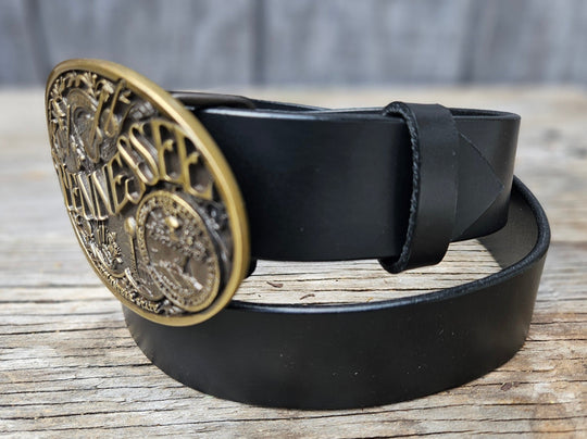 This Tennessee Belt with Montana Silversmith Buckle makes a great Combo. Features a 1 1/2" strap. Choose color: Distressed Brown or Black. The edges are beveled and finished. Available lengths from 34" to 44". The buckle is an Antiqued brass colored Tennessee State Buckle snapped in place. Belt is handmade in our shop in Smyrna, TN, just outside of Nashville