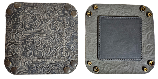 Our Western Leather Valet Tray, crafted in Smyrna, TN, easily folds flat by unsnapping its four Antique Brass snaps—perfect for travel. Its handy 4" x 4" size keeps your everyday essentials like keys and wallet organized. Featuring a classic embossed floral design, it pairs effortlessly with any style. Pick your favorite from four Black and Brown combos! Colors my vary.
