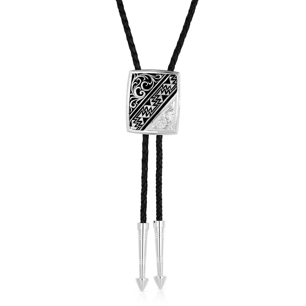 Discover the Four Winds of the Southwest Bolo Tie by Montana Silversmiths, available at our Smyrna, TN store near Nashville. This playful accessory showcases intricate filigree, bold Southwestern geometric designs, and detailed silver engravings. It comes with a 36-inch genuine leather cord and silver-tone tips, making it a fun and stylish match for any shirt in your wardrobe.