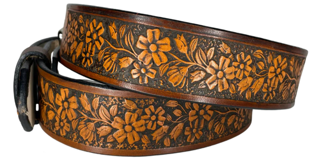 "The Beulah Land" is a handmade real leather belt made from a single strip of cowhide shoulder leather that is 8-10 oz. or approx. 1/8" thick. It has hand burnished (smoothed) edges and summer flowers embossed in 3 color options.  The antique nickel plated solid brass buckle is snapped in place with heavy snaps.  This belt is made just outside Nashville in Smyrna, TN.