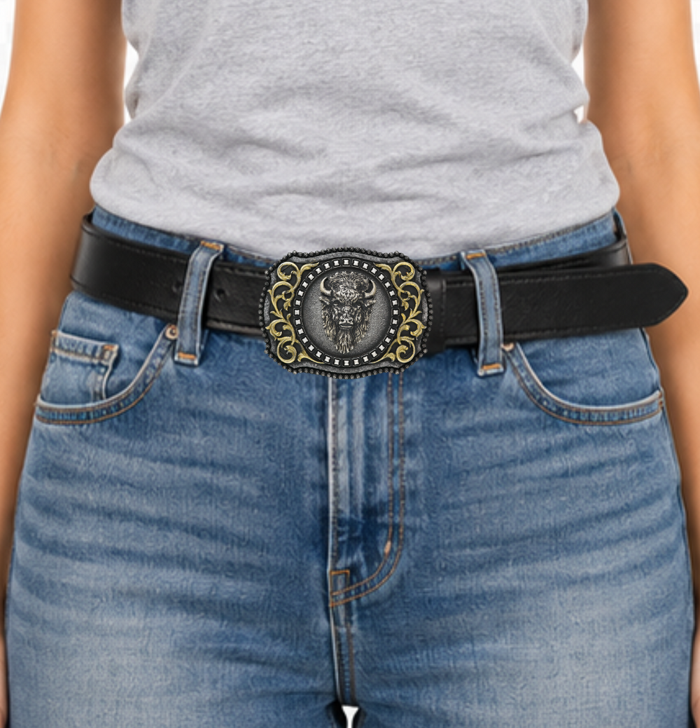 The Buffalo, a beloved Western symbol, now has a stylish and approachable accessory to complete your look. This rectangular belt buckle features a Brass-colored western scroll design with a Tantanka head in the center, surrounded by rounded bead edges. Measuring 3" tall by 4" wide, it's perfectly sized to fit belts up to 1 1/2" wide. You can find it at our retail shop in Smyrna, TN, located just outside of Nashville, or online. 