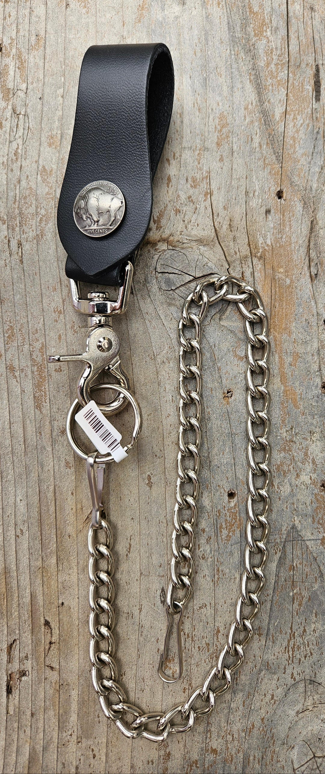 This Vintage style Steel Chain with a classic Buffalo Nickel Concho. Simple but Sturdy and will keep your wallet where it needs to be. The Leather loop, decorated with a Buffalo Nickel, attaches to your jeans and the split ring attaches to your wallet. Chrome plated. Ride down and get yours in our shop just outside Nashville in Smyrna, TN.

18" Chain Length
Leather belt tab