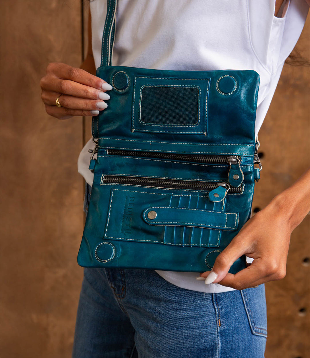 Cadence is a versatile 3-in-1 essential crafted from full-grain, Artisan vegetable-tanned leather. Effortless transitions from wallet to clutch to crossbody with a wrist strap and adjustable body strap, both are detachable. Exterior zip pocket. Sleek magnetic closure with minimalist profile. Interior has two zippered compartments, ID window, and 6 card slots. Measures 8" L x 5" H x 1.5" D. Handmade and hand-finished in León, Mexico. Made by Bed/Stu and now stocked at our Smyrna, TN store.