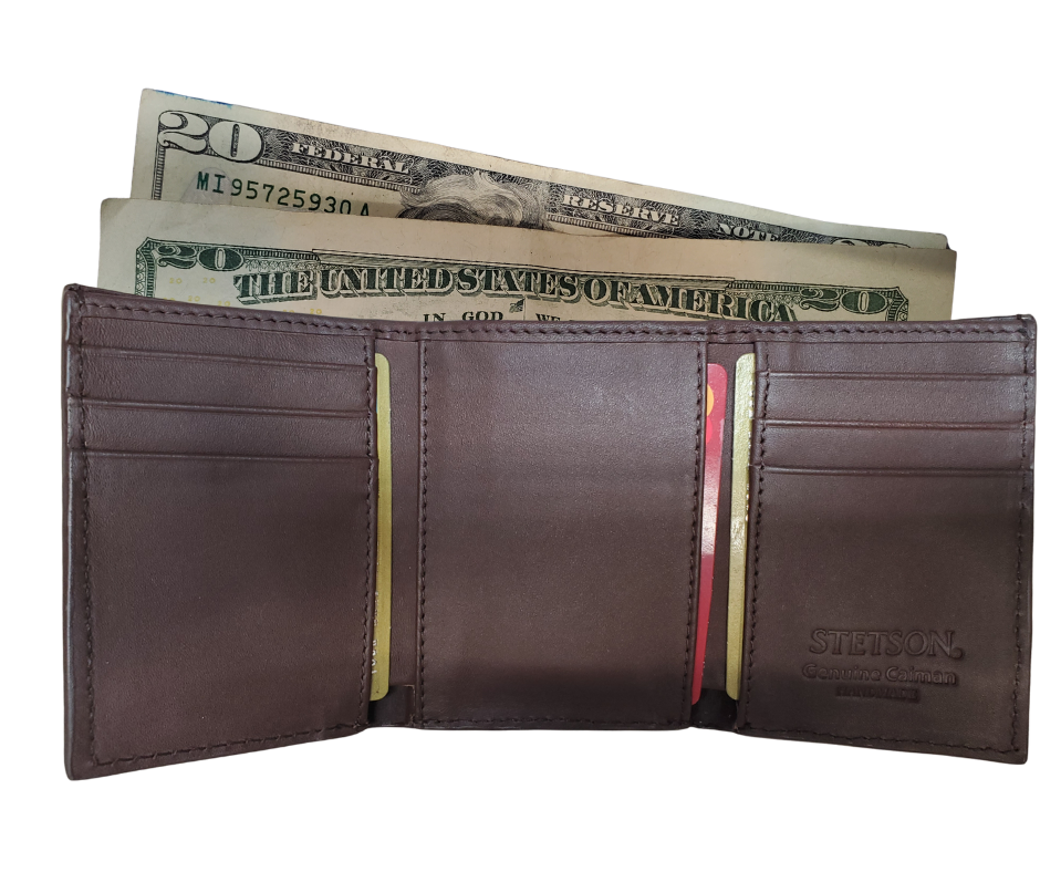 Made from authentic Black or Cigar colored Caiman leather, this bi-fold wallet blends classic western flair with bold luxury. The Stetson name guarantees top-notch craftsmanship and meticulous detail. It offers 6 card slots, 3 hidden pockets underneath, and a spacious cash compartment. Available now at our Smyrna, TN store, just a quick 30-minute drive from downtown Nashville. Proudly made in Mexico.
