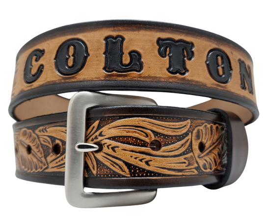 Get ready for the Rodeo adventure of The "Calgary" Name Belt! This one-of-a-kind belt features a 1 1/2" width and is hand-stained with a strip of vegetable tanned leather. The design includes a Classic Tooled Vine center pattern, while the solid brass buckle in antique nickel finish adds a touch of ruggedness. Handcrafted at our shop in Smyrna, Tennessee, just outside Nashville.