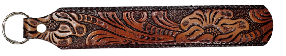 Long Leather embossed Key Fobs that are made in our Smyrna, TN shop. Longer length makes them easier to find in your bag or pocket. Choose popular Designs.

Size is 8"L x 1 1/4" Designs may vary from picture slightly