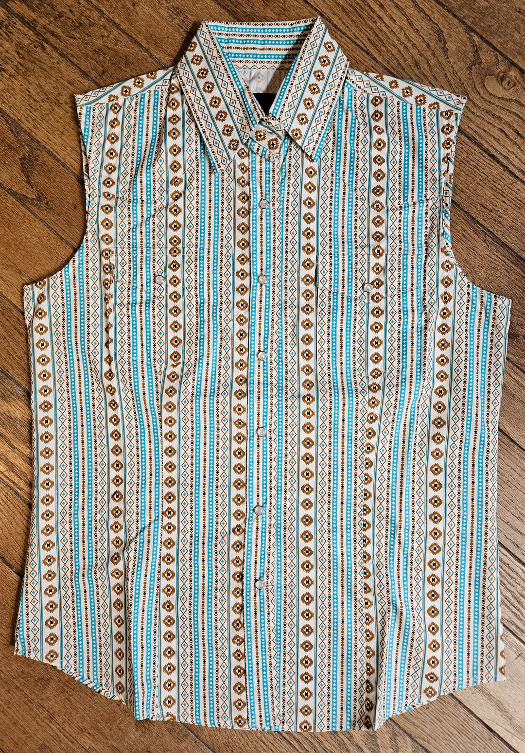 The Cowgirl Legend Ladies Southwestern Shirt offered in Sleeveless and Long Sleeve. Complete with two front flap pockets, pearl snap details in a classic southwest pattern. These are always in style! Available in our Smyrna, TN shop not far from the Miller Coliseum in Murfreesboro. Imported

Details: Pearl Snaps, 2 Pockets, Yokes, 100% Cotton