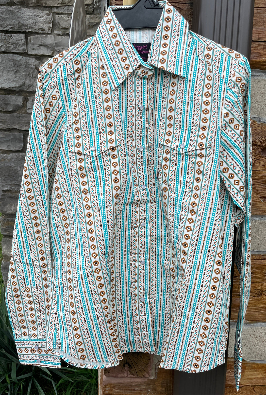 The Cowgirl Legend Ladies Southwestern Shirt offered in Sleeveless and Long Sleeve. Complete with two front flap pockets, pearl snap details in a classic southwest pattern. These are always in style! Available in our Smyrna, TN shop not far from the Miller Coliseum in Murfreesboro. Imported

Details: Pearl Snaps, 2 Pockets, Yokes, 100% Cotton