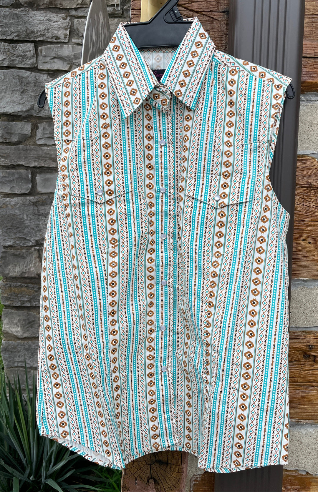 The Cowgirl Legend Ladies Southwestern Shirt offered in Sleeveless and Long Sleeve. Complete with two front flap pockets, pearl snap details in a classic southwest pattern. These are always in style! Available in our Smyrna, TN shop not far from the Miller Coliseum in Murfreesboro. Imported

Details: Pearl Snaps, 2 Pockets, Yokes, 100% Cotton