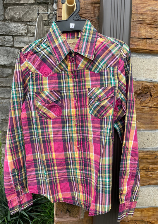 The Cowgirl Legend Ladies Spunky Plaid Shirt offered in long sleeve. A dominant hot pink is accented with yellows, whites, greens, and grays blended together in a traditional plaid pattern. Complete with two front flap pockets, and pearl snaps. These shirts are always in style,and especially if you want to keep Steve guessing what you&