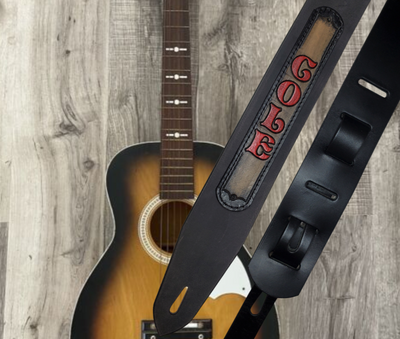 Acoustic Guitars and Great Songs and Lyrics have been staple for years in Country music!  "This 2" or 2 1/2" wide Guitar Strap is a nod to that classic influence. The main Body of the strap is approx. 1/8" thick Black Leather with a CUSTOMIZABLE LEATHER NAME PATCH. The classic adjustment style goes from approx. 42" to 56" at it's longest . Made just outside Nashville in our Smyrna, TN. shop. It will need a bit of time to "break in" but will get a great patina over time.  