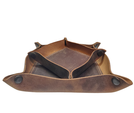 Our Rustic Distressed Leather Valet Tray, crafted in Smyrna, TN, easily folds flat by unsnapping its four Antique Brass snaps—perfect for travel. Its handy 4" x 4" size keeps your everyday essentials like keys and wallet organized. It pairs effortlessly with any style. Colors my vary.

Med. Approx. 8"x 8" (snapped)
Small Approx. 4.5"x 4.5" (snapped)