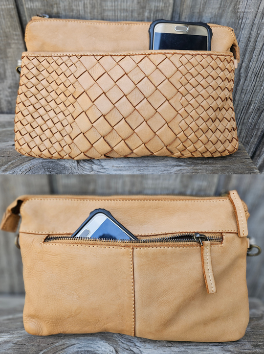 The Eve is made from soft tumbled leather and has a Woven front. The back side has a zippered pocket that will hold most smaller phone sized items. The main open inside pocket has one zippered pocket, 2 open top pockets 4 card size slots and one more smaller pocket next to to the cards. May be carried with the Wrist loop or as a Crossbody style with the included strap. The liner is a cotton fabric. Available now at our store in Smyrna, TN!

Measurements: 10" x 1" x 6"