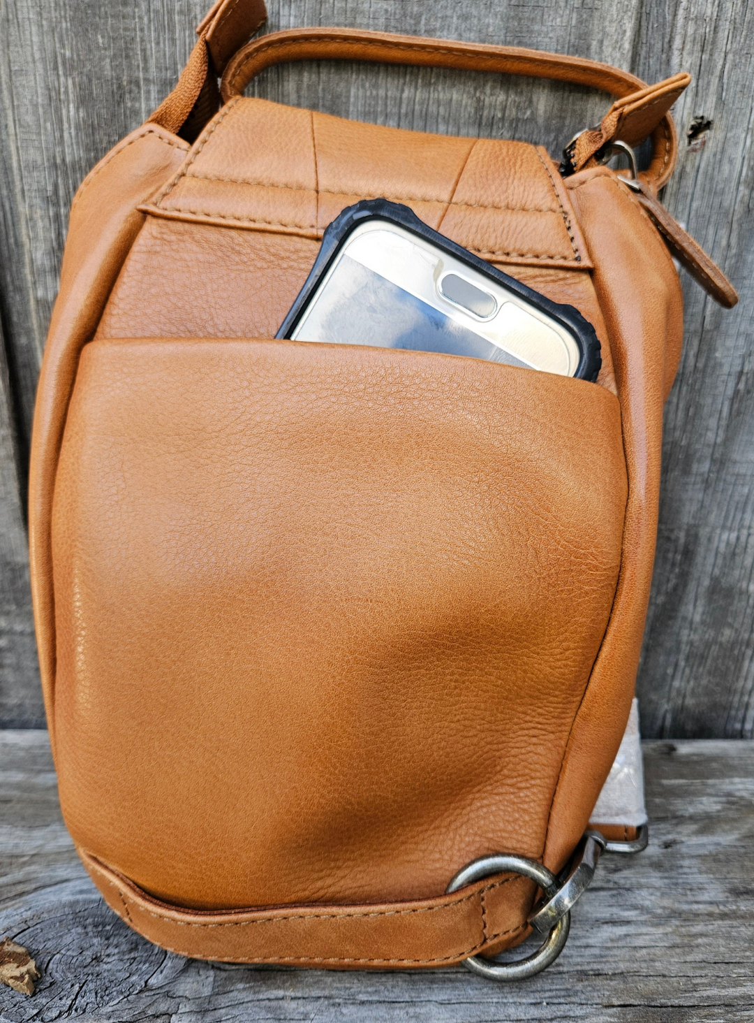 Our Lea Anne bag is great for some one who is has the Minimalist mind set. Not to big or small. The Lea Anne may be hand carry or be worn sling style. It has a back open top pocket on the back side, the inside is one main pocket with one smaller zippered and one open top pocket. Made from soft tumbled leather and lined with cotton fabric. Available now at our store in Smyrna, TN.

Measurements: 6" x 1.5" x 10"