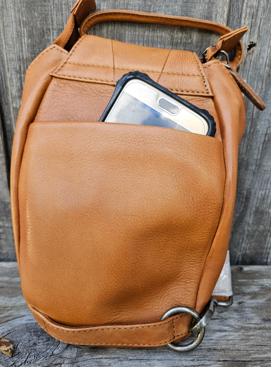 Our Lea Anne bag is great for some one who is has the Minimalist mind set. Not to big or small. The Lea Anne may be hand carry or be worn sling style. It has a back open top pocket on the back side, the inside is one main pocket with one smaller zippered and one open top pocket. Made from soft tumbled leather and lined with cotton fabric. Available now at our store in Smyrna, TN.

Measurements: 6" x 1.5" x 10"