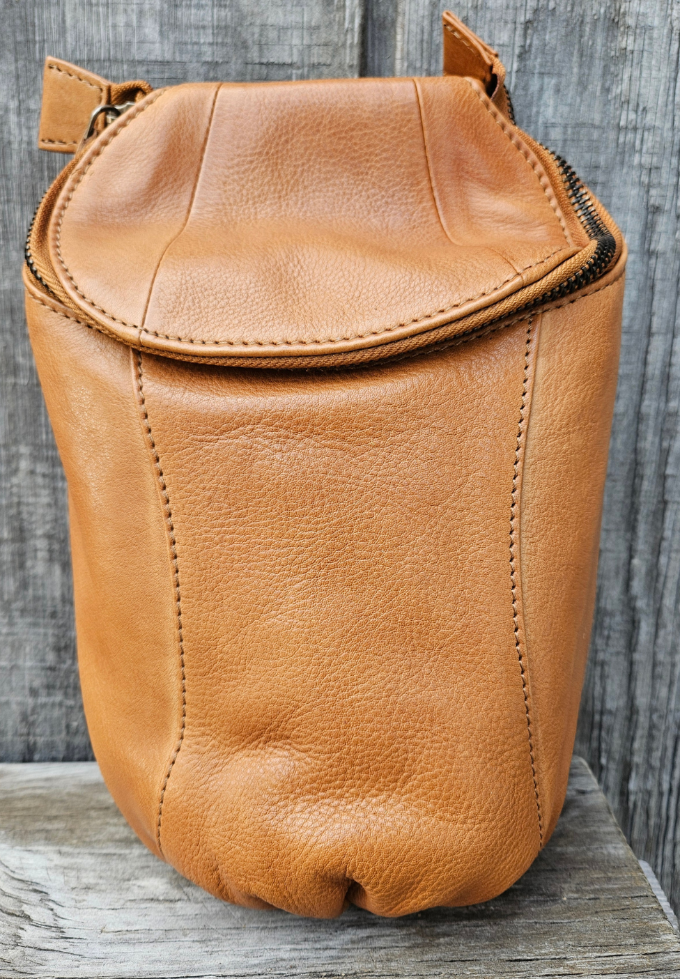 Our Lea Anne bag is great for some one who is has the Minimalist mind set. Not to big or small. The Lea Anne may be hand carry or be worn sling style. It has a back open top pocket on the back side, the inside is one main pocket with one smaller zippered and one open top pocket. Made from soft tumbled leather and lined with cotton fabric. Available now at our store in Smyrna, TN.

Measurements: 6" x 1.5" x 10"