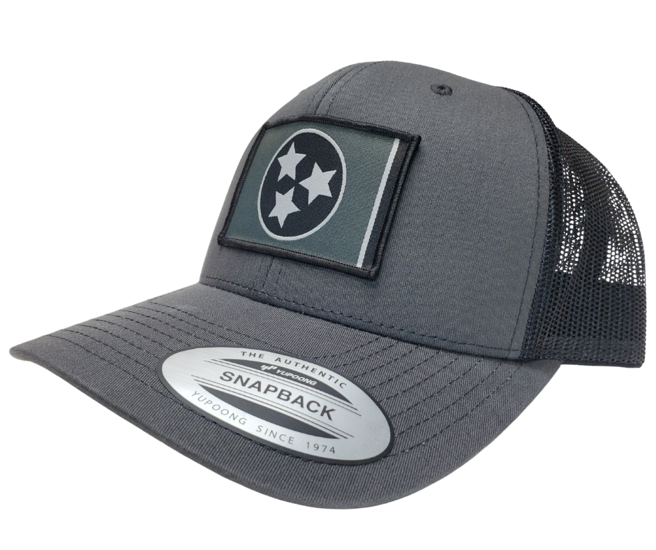 The Three stars on this Structured cap represent the three divisions of Tennessee: West, Middle and East. “They are arranged in such a way that not one star has prominence over the other. Sport your Tennessee support with our grey mesh cap featuring the iconic Tennessee Tri Star flag logo. Shop now at our Smyrna, TN store or online. Snap back adjustment.