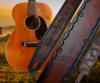 Named after the song "I was raised on Country Sunshine this Guitar Strap has the hint of some flowers and you pick your NAME font and color. It's made from 1/8" thick drum dyed vegetable tanned cow hide and is hand finished.  The main strap is made from a single strip of leather with beveled and painted edges.  Choose a 2" or 2 1/2" wide strap with a classic adjustment style up to approx. 60". Made just outside Nashville in Smyrna, TN.