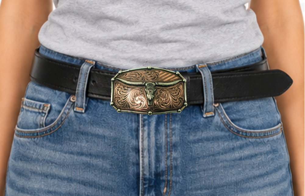 The Chief Longhorn buckle  These buckles are made from German Silver (nickel and brass alloy) or iron metal base. Some buckles have motifs made of copper, iron or brass and some are adorned with synthetic stones. These are all handcrafted. Each piece is punched, cut, soldered, engraved, polished and painted by our talented metal workers.  Available in our Smyrna TN shop. Width 4.5” Height 3”
Fits Standard 1.5” belts