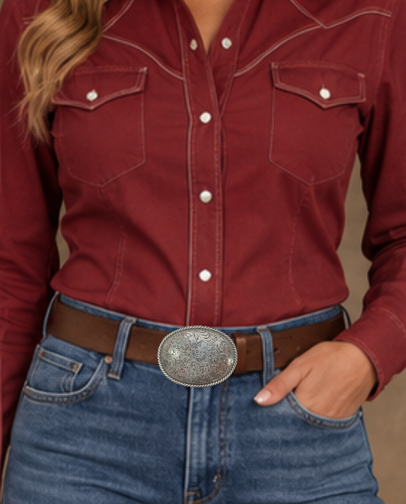 This oval shaped buckle by Nocona has a rope design around the border. It is chrome colored with scroll design etched appearance on surface.  Measures 2 3/4" tall by 3 3/4" wide and fits belts up to 1 1/2" wide.  It is available for purchase in our retail shop in Smyrna, TN, just outside Nashville and also on our online store. Made in Taiwan. Back of buckle pictured.
