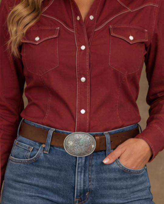 This oval shaped buckle by Nocona has a rope design around the border. It is chrome colored with scroll design etched appearance on surface.  Measures 2 3/4" tall by 3 3/4" wide and fits belts up to 1 1/2" wide.  It is available for purchase in our retail shop in Smyrna, TN, just outside Nashville and also on our online store. Made in Taiwan. Back of buckle pictured.