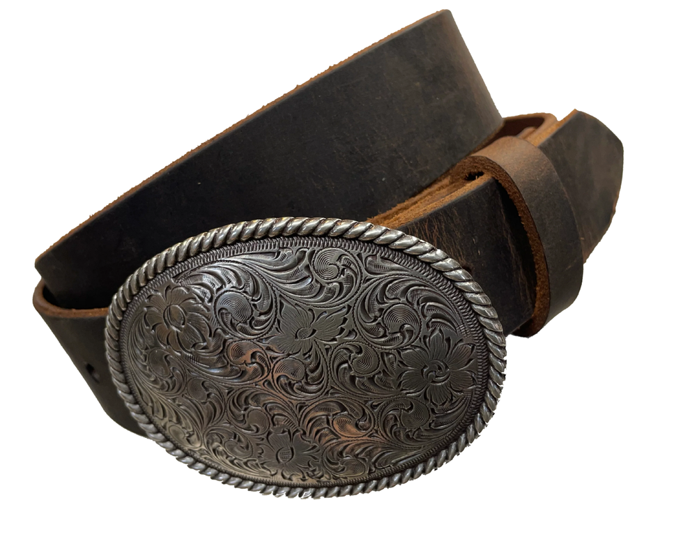 This oval shaped buckle has a rope design around the border. It is chrome colored with scroll design etched appearance on surface.  Measures 2 3/4" tall by 3 3/4" wide. Buckle is made in Taiwan. Belt is a solid strip of leather and made in our shop in Smyrna, TN, just outside Nashville. It is 1 1/2" wide and available in sizes 34"-44" and colors distressed brown, black, and dark brown.  It is available for purchase in our retail shop and online store. Distressed brown.