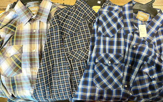 It doesn't get much anymore classic than a plaid pearl snap western shirt. Complete with two front flap pockets, pearl snap details in the vintage plaid pattern. These never go out of style, always a in style! Available in our Smyrna, TN shop just outside Nashville. Imported

Note: the Plaid colors Blue, Red, and Brown, or Black will always be the base color BUT the tones may change occasionally. The yokes ,snaps will be the same as well.

Details: Snaps, 2 Pockets, Yokes