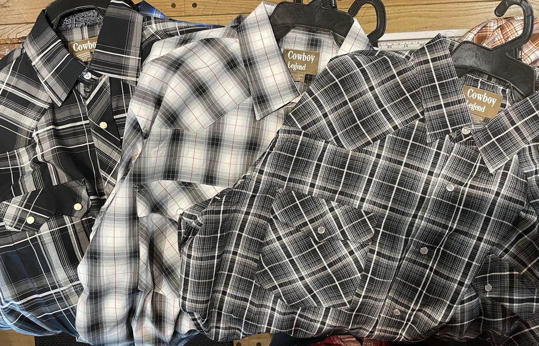 It doesn't get much anymore classic than a plaid pearl snap western shirt. Complete with two front flap pockets, pearl snap details in the vintage plaid pattern. These never go out of style, always a in style! Available in our Smyrna, TN shop just outside Nashville. Imported

Note: the Plaid colors Blue, Red, and Brown, or Black will always be the base color BUT the tones may change occasionally. The yokes ,snaps will be the same as well.

Details: Snaps, 2 Pockets, Yokes