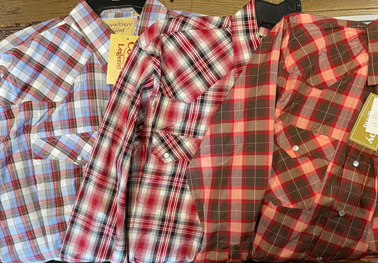 It doesn't get much anymore classic than a plaid pearl snap western shirt. Complete with two front flap pockets, pearl snap details in the vintage plaid pattern. These never go out of style, always a in style! Available in our Smyrna, TN shop just outside Nashville. Imported

Note: the Plaid colors Blue, Red, and Brown, or Black will always be the base color BUT the tones may change occasionally. The yokes ,snaps will be the same as well.

Details: Snaps, 2 Pockets, Yokes