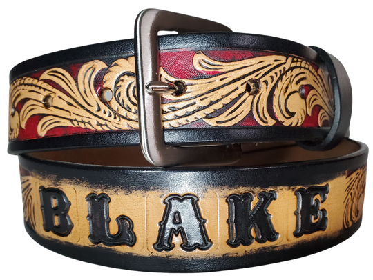 This DELUXE Rustler Name Leather Belt features a classic western Scroll pattern embossed on a 9-10 oz. vegetable-tanned cowhide. You may customize the buckle with the added snaps. It is named Deluxe because of the additional color added to the background of the pattern. This product is crafted with care in our Smyrna, TN shop, just outside Nashville, TN.