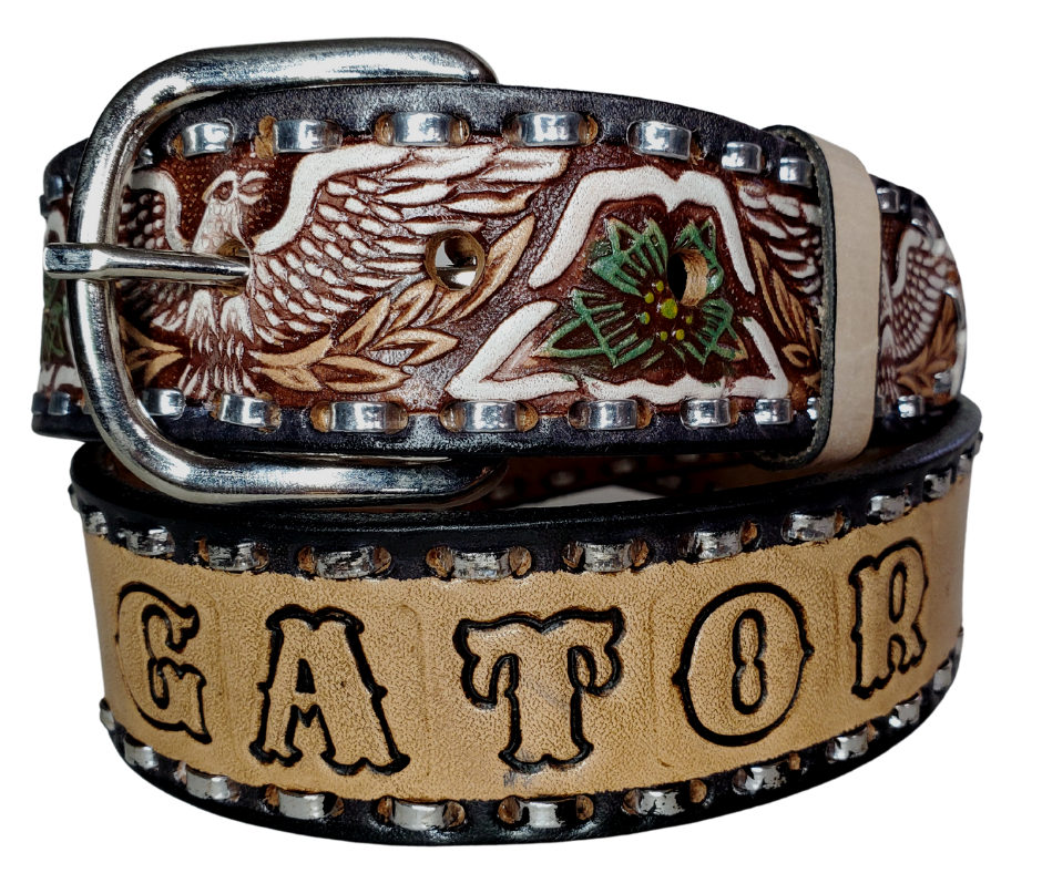 The Dimestore Cowboy leather belt is a classic Vintage Throwback Style Western belt. Complete with silver Buck Stitching and a embossed eagle design in Black/Antique White/Blue coloring. A 1 1/2" width Full grain vegetable tanned cowhide, Width 1 1/2" and includes Nickle plated  buckle Smooth burnished painted edges. Buckle snaps in place for easy changing if desired. In stock at our Smyrna, TN shop. 