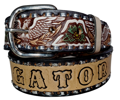 The Dimestore Cowboy leather belt is a classic Vintage Throwback Style Western belt. Complete with silver Buck Stitching and a embossed eagle design in Black/Antique White/Blue coloring. A 1 1/2" width Full grain vegetable tanned cowhide, Width 1 1/2" and includes Nickle plated  buckle Smooth burnished painted edges. Buckle snaps in place for easy changing if desired. In stock at our Smyrna, TN shop. 