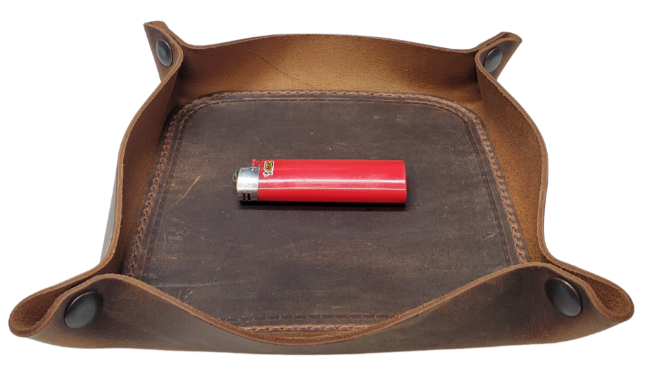 Our Rustic Distressed Leather Valet Tray, crafted in Smyrna, TN, easily folds flat by unsnapping its four Antique Brass snaps—perfect for travel. Its handy 4" x 4" size keeps your everyday essentials like keys and wallet organized. It pairs effortlessly with any style. Colors my vary.

Med. Approx. 8"x 8" (snapped)
Small Approx. 4.5"x 4.5" (snapped)