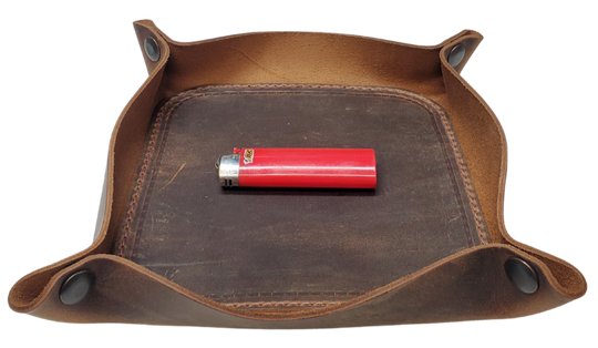 Our Rustic Distressed Leather Valet Tray, crafted in Smyrna, TN, easily folds flat by unsnapping its four Antique Brass snaps—perfect for travel. Its handy 4" x 4" size keeps your everyday essentials like keys and wallet organized. It pairs effortlessly with any style. Colors my vary.

Med. Approx. 8"x 8" (snapped)
Small Approx. 4.5"x 4.5" (snapped)