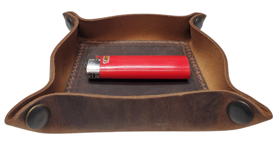 Our Rustic Distressed Leather Valet Tray, crafted in Smyrna, TN, easily folds flat by unsnapping its four Antique Brass snaps—perfect for travel. Its handy 4" x 4" size keeps your everyday essentials like keys and wallet organized. It pairs effortlessly with any style. Colors my vary.

Med. Approx. 8"x 8" (snapped)
Small Approx. 4.5"x 4.5" (snapped)
