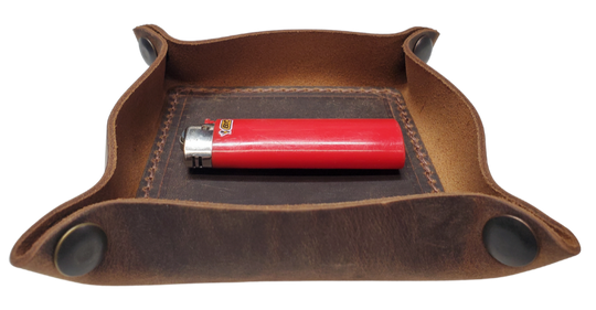 Our Rustic Distressed Leather Valet Tray, crafted in Smyrna, TN, easily folds flat by unsnapping its four Antique Brass snaps—perfect for travel. Its handy 4" x 4" size keeps your everyday essentials like keys and wallet organized. It pairs effortlessly with any style. Colors my vary.

Med. Approx. 8"x 8" (snapped)
Small Approx. 4.5"x 4.5" (snapped)