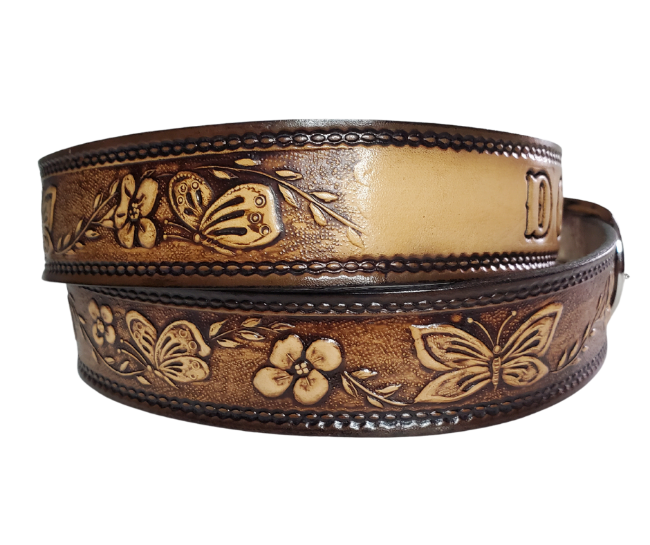  This stylish leather belt features beautiful flowers and butterfly artwork that is sure to draw attention. The easy-change metal buckle makes for comfortable wear and makes it easy to add your own buckle. Perfect for adding a unique touch to any wardrobe. This belt is stocked in our shop outside Nashville in Smyrna, TN.