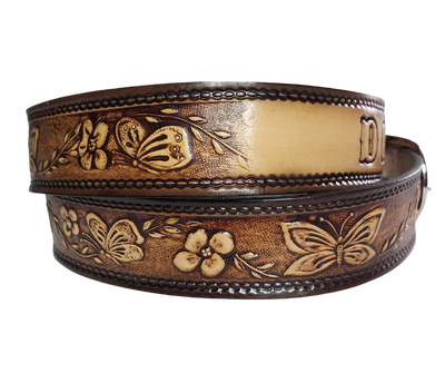  This stylish leather belt features beautiful flowers and butterfly artwork that is sure to draw attention. The easy-change metal buckle makes for comfortable wear and makes it easy to add your own buckle. Perfect for adding a unique touch to any wardrobe. This belt is stocked in our shop outside Nashville in Smyrna, TN.