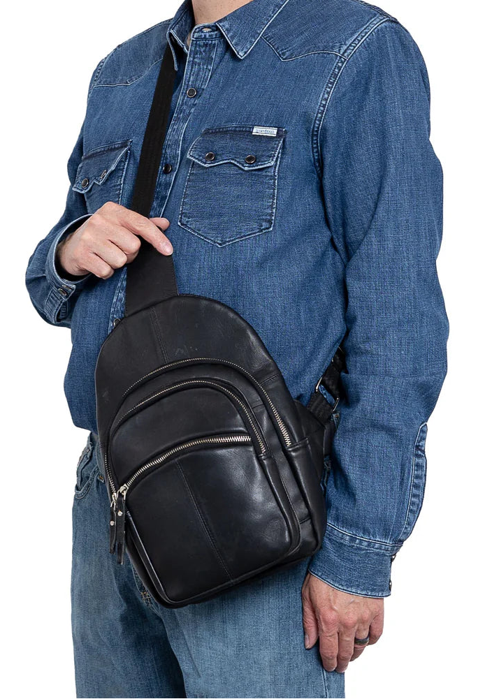 The Harley Sling Backpack is crafted from soft, genuine lambskin leather. The full-back compartment has a zippered pocket, while the middle zippered pocket serves as the concealed carry compartment. The bottom zippered pocket provides extra storage for your essentials. The back of the backpack is lined with breathable nylon mesh, for ventilation. Part of our Carry Conceal Handbags at our Smyrna, TN shop.