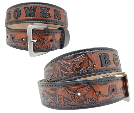 Get ready for an unforgettable climb to the top with The "Eagle Mountain" Name Belt! This one-of-a-kind belt features a 1 1/2" width and is hand-stained with a strip of vegetable tanned leather. The bold design includes a embossed Stitch border and Eagle center pattern, while the solid brass buckle in antique nickel finish adds a touch of ruggedness. Handcrafted at our shop in Smyrna, Tennessee, just outside Nashville.